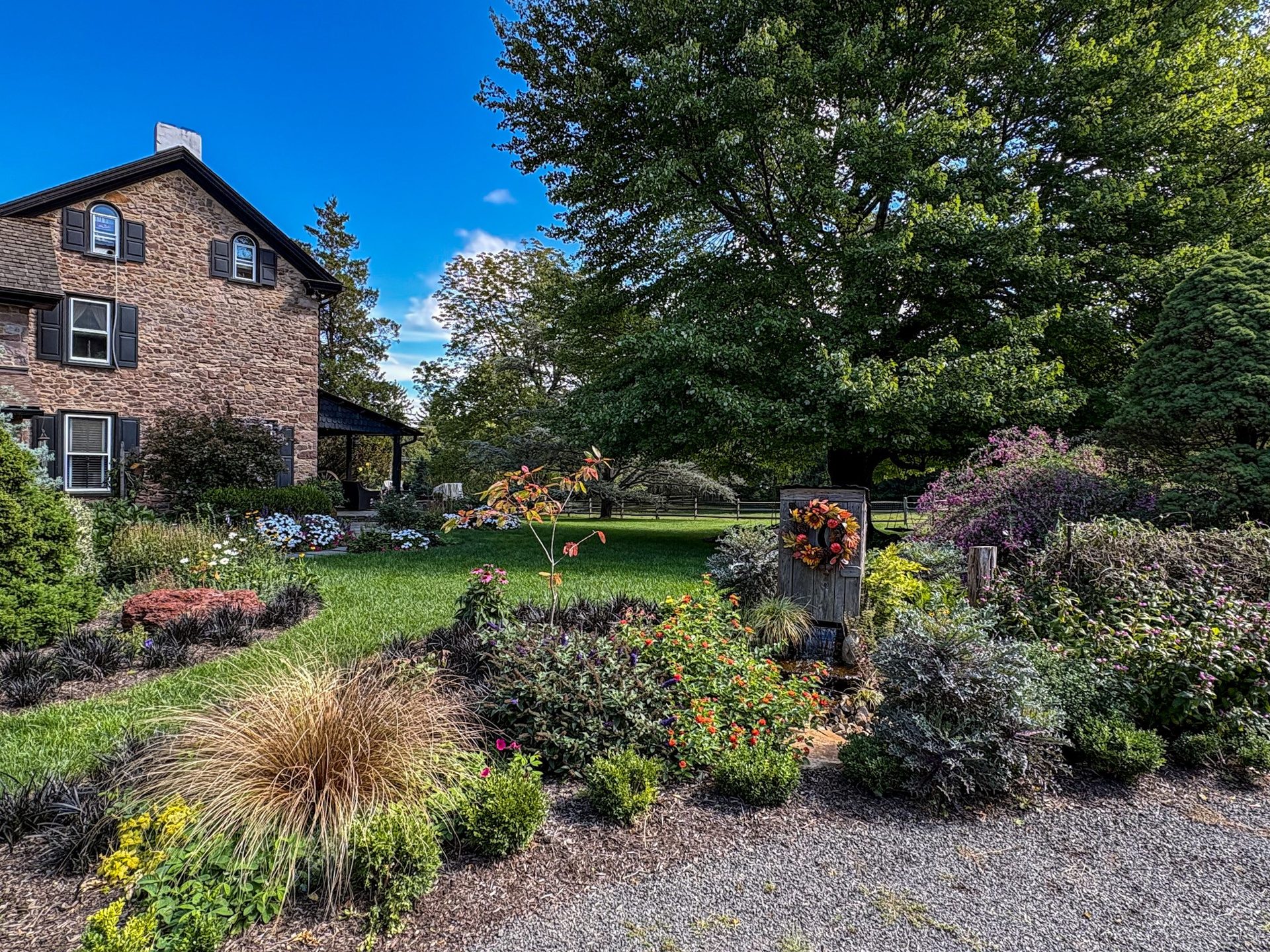 Landscape beds and stone water feature beside the Horsham house