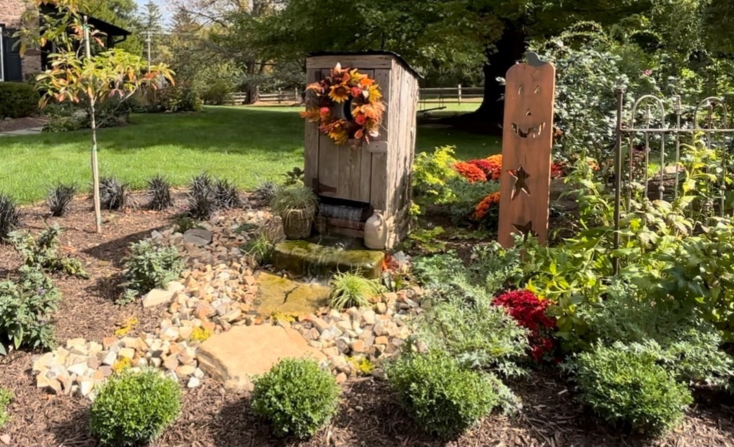Stone water feature with surrounding plants